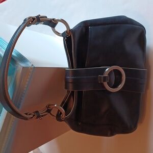 Small black satchel bag with magnetic closure and silver rings